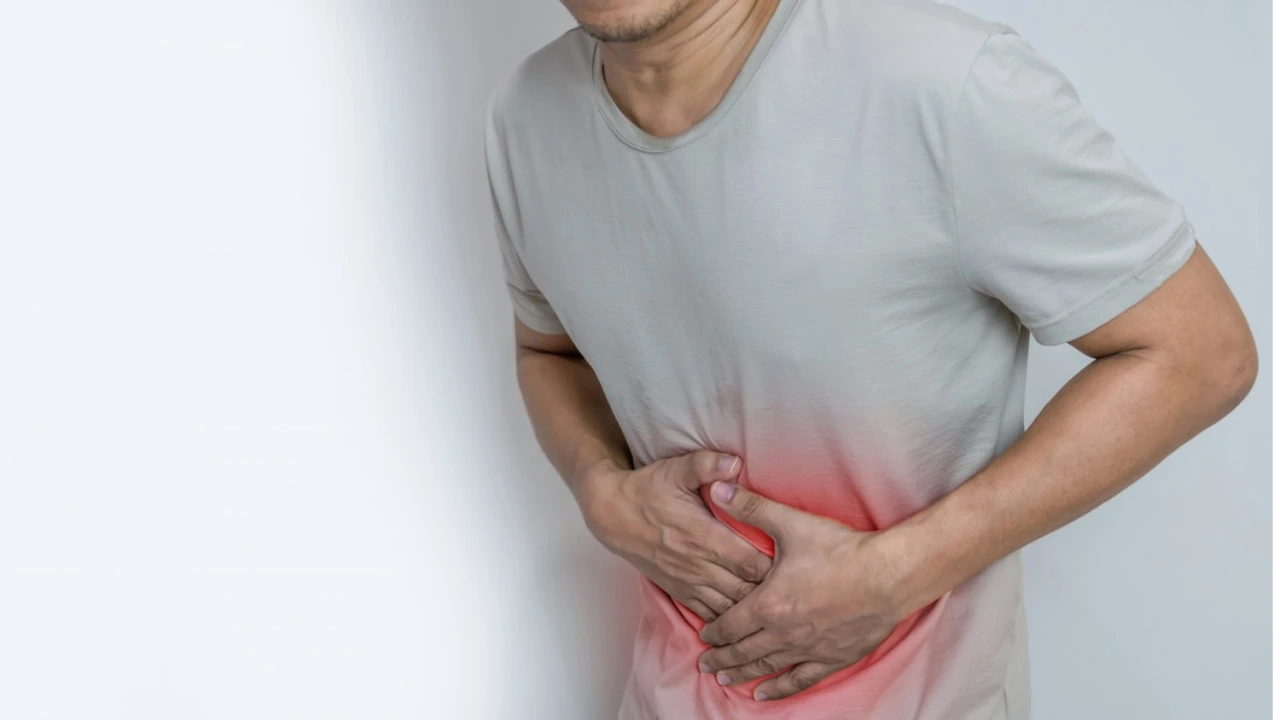 man-suffering-from-stomach-ache-with-both-palm-aro